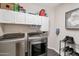 Laundry room with washer, dryer, and ample storage at 1931 W Mulberry Dr, Chandler, AZ 85286