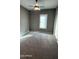 Bright bedroom featuring a ceiling fan and window shutters at 20982 E Mockingbird Dr, Queen Creek, AZ 85142