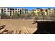 View of a backyard with a retaining wall and a fence looking out at neighborhood buildings at 21048 N 58Th St, Phoenix, AZ 85054