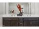 Elegant bathroom featuring a double sink vanity with modern faucets and decor at 21048 N 58Th St, Phoenix, AZ 85054