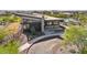 Exterior view of a modern clubhouse with a pool, unique architecture, and neatly landscaped surroundings at 21048 N 58Th St, Phoenix, AZ 85054