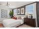 Bright main bedroom showcasing a large bed, wall art, and natural light at 21048 N 58Th St, Phoenix, AZ 85054