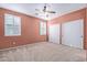 Bedroom with light peach walls, ceiling fan, and double closets at 2331 W Kristina Ave, San Tan Valley, AZ 85144