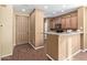 Kitchen entry with light brown cabinets and wood floors at 2331 W Kristina Ave, San Tan Valley, AZ 85144