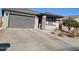 New construction home with gray exterior, two-car garage, and driveway at 24550 W Mohave St, Buckeye, AZ 85326