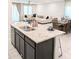 Modern kitchen island with granite countertop and gray cabinets at 24550 W Mohave St, Buckeye, AZ 85326