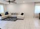 Living area featuring an L-shaped sofa and tile flooring at 24550 W Mohave St, Buckeye, AZ 85326