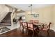 Dining room features hardwood flooring, chandelier, and view into the entry foyer with staircase at 2551 E Saratoga St, Gilbert, AZ 85296