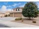 Two-story house with tan exterior, three-car garage, and desert landscaping at 2551 E Saratoga St, Gilbert, AZ 85296