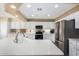 Bright kitchen with stainless steel appliances, white cabinets, and a large kitchen island at 2551 E Saratoga St, Gilbert, AZ 85296