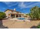 Backyard pool featuring an outdoor kitchen area with covered patio, desert landscaping, and a second story balcony at 2551 E Saratoga St, Gilbert, AZ 85296