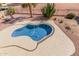 Aerial view of a uniquely shaped pool in a backyard with desert landscaping and concrete deck at 2551 E Saratoga St, Gilbert, AZ 85296