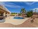 Backyard pool features surrounding desert landscaping and an outdoor kitchen area with a covered patio at 2551 E Saratoga St, Gilbert, AZ 85296