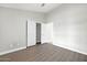 Simple bedroom with wood-look floors and sliding door closet at 2605 N 133Rd Ave, Goodyear, AZ 85395