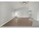 Spacious living room with wood-look flooring and a ceiling fan at 2605 N 133Rd Ave, Goodyear, AZ 85395