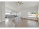 Open living room and kitchen area with wood-look flooring and high ceiling at 2605 N 133Rd Ave, Goodyear, AZ 85395