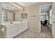 Bathroom with double sink vanity, large mirror, and decorative floor at 2626 S Southwind Dr, Gilbert, AZ 85295