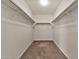 Walk-in closet with carpeted floor and rod and shelf storage system at 2626 S Southwind Dr, Gilbert, AZ 85295