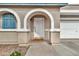 Close-up of front porch showcasing arched entryway and a view of the garage at 2626 S Southwind Dr, Gilbert, AZ 85295