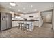 Spacious kitchen with stainless steel refrigerator, island, and white cabinetry at 2626 S Southwind Dr, Gilbert, AZ 85295