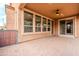 Covered patio with brick flooring, ceiling fan and sliding glass door at 28837 N 127Th Ave, Peoria, AZ 85383