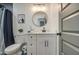 Modern bathroom with white vanity, black matte fixtures, and a walk-in shower at 3530 W Marlette Ave, Phoenix, AZ 85019