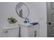 Stylish bathroom with a white vanity, black matte faucet, and round mirror at 3530 W Marlette Ave, Phoenix, AZ 85019