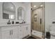 Elegant bathroom with dual sinks, walk-in shower, and arched mirrors at 3530 W Marlette Ave, Phoenix, AZ 85019