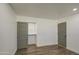 Well-lit bedroom featuring wood-look flooring and dual closets at 3530 W Marlette Ave, Phoenix, AZ 85019