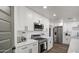 Modern kitchen featuring white cabinets, stainless steel appliances, and quartz countertops at 3530 W Marlette Ave, Phoenix, AZ 85019