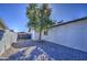 Landscaped side yard with gravel and a mature tree, offering privacy at 3530 W Marlette Ave, Phoenix, AZ 85019