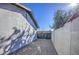 Side yard with gravel and a metal gate at 3530 W Marlette Ave, Phoenix, AZ 85019