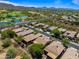 Aerial view of a community with houses, golf course, and lake at 41604 N Cedar Chase Rd, Anthem, AZ 85086