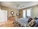 Bedroom with patio access, ceiling fan, and light wood flooring at 41604 N Cedar Chase Rd, Anthem, AZ 85086