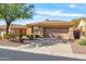 Tan house with a two-car garage and well-maintained landscaping at 41604 N Cedar Chase Rd, Anthem, AZ 85086