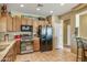 Kitchen with wood cabinets, stainless steel appliances, and tile floors at 41604 N Cedar Chase Rd, Anthem, AZ 85086