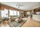 Open living room with hardwood floors, neutral decor, and a view of the dining area at 41604 N Cedar Chase Rd, Anthem, AZ 85086