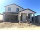 Two-story house with a modern design and attached garage at 43400 N Wollemi St, Queen Creek, AZ 85140