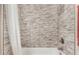 Bathroom with shower/tub and stone tile surround at 44429 N 1St Dr, New River, AZ 85087