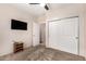 Bedroom with TV, carpet, and double door closet at 44429 N 1St Dr, New River, AZ 85087