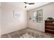 Bright bedroom with ceiling fan, carpet, and built-in shelving at 44429 N 1St Dr, New River, AZ 85087