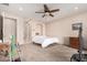 Bedroom with ceiling fan, carpeted floors, and built-in shelving at 44429 N 1St Dr, New River, AZ 85087