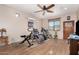 Home gym with various exercise equipment and wood flooring at 44429 N 1St Dr, New River, AZ 85087