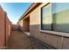 View of home's backyard with block wall and small patio at 4511 W Valencia Dr, Laveen, AZ 85339