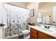 Cozy bathroom featuring a single sink vanity, toilet, and shower with floral curtain at 4511 W Valencia Dr, Laveen, AZ 85339