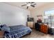 Bedroom with a bed, desk, workspace, and ceiling fan at 4511 W Valencia Dr, Laveen, AZ 85339