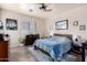 Comfortable bedroom featuring a decorative blue patterned bed spread and a ceiling fan at 4511 W Valencia Dr, Laveen, AZ 85339