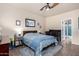 Well-lit bedroom with ceiling fan, and a decorative blue patterned bed spread at 4511 W Valencia Dr, Laveen, AZ 85339