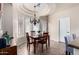 Charming dining room with elegant chandelier and lots of natural light from the windows at 4511 W Valencia Dr, Laveen, AZ 85339