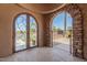 Arched entryway featuring stone accents and wrought iron gate at 4511 W Valencia Dr, Laveen, AZ 85339